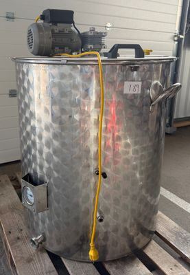 un grand récipient métallique posé sur une palette dans un garage