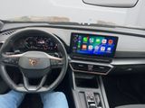 someone is sitting in the driver ' s seat of a car with their feet on the steering wheel