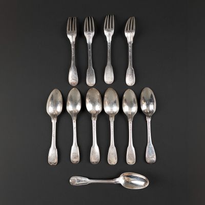 six silver spoons and two silver spoons on a black surface