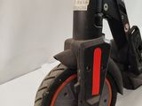 a scooter that is sitting on a white surface