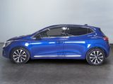 a blue car is parked in a room with a white wall