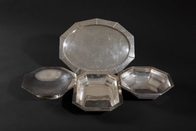 a silver plate with four compartments on a black surface