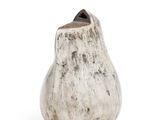 a white vase with a black top sitting on a white surface