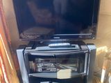 a flat screen tv sitting on a stand in a living room