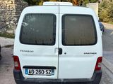 a small white van parked on the side of the road