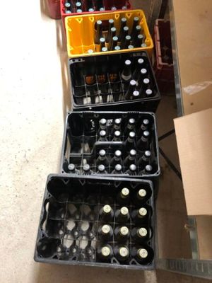 bottles of beer are stacked on top of each other on a table