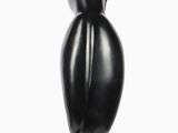 a black sculpture of a bird sitting on a base