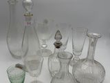 a lot of glass vases and glasses on the table