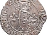 an old silver coin with a crown on top of it