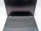 the laptop is open on a white surface with a black keyboard