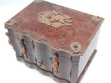 a small wooden box with carvings on it
