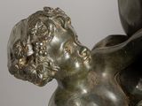 bronze statue of a woman holding a child in her arms