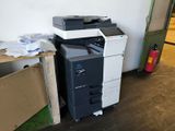 a black and white printer sitting on top of a desk