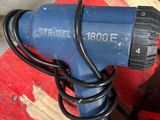 a blue and black electric drill on a red pallet