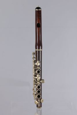 a close up of a flute on a table with a white background