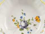 a close up of a bowl with flowers on it