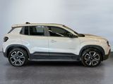a white suv is parked in a showroom with a white wall