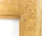 a picture of a gold picture frame on a white wall