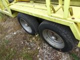 a large yellow truck with a flat bed on the back of it