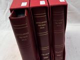 three red books are stacked on top of each other on a white surface