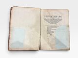 an old book open on a white surface