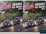 these are two racing cars on a road with trees in the background