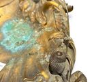 a statue of a man and a woman sitting on top of a fish