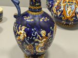 three blue and gold vases sitting on a table