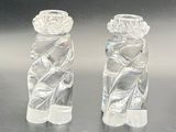 pair of clear glass candlestick holders on a shiny surface