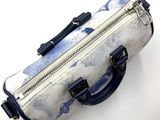 a blue and white bag with a handle on a white surface