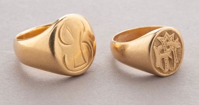 a pair of gold rings with initials on them