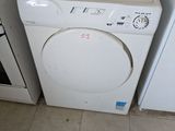 two washers and a dryer in a small room