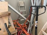 a pile of assorted construction materials and tools in a room