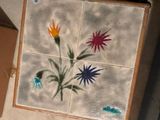 a picture of a tile with flowers painted on it