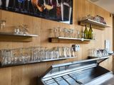 many glasses and bottles on the shelves in the room