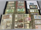 several different types of paper money are displayed on a table