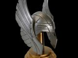 a close up of a statue of a helmet with wings on it
