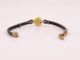 a black leather bracelet with a gold plated clasp