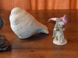 three figurines of birds sitting on a wooden table