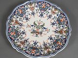 a close up of a blue and white plate with flowers on it