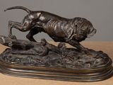 bronze statue of a dog running on a log with a bird in its mouth