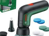a close up of a green and black electric polisher with a box