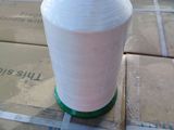 a white spool of thread on the ground next to a box