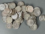 a pile of silver coins sitting on a table