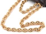 a black purse with gold chains and a chain around it
