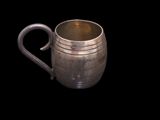 a silver cup with writing on it on a black background