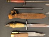 many different types of knives on a table