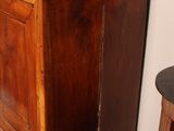 a wooden cabinet with a mirror on top of it