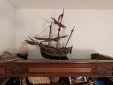 a wooden shelf with a ship on top of it