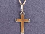 a close up of a cross on a necklace on a mannequin mannequin mannequin mannequin mannequin mannequin mannequin